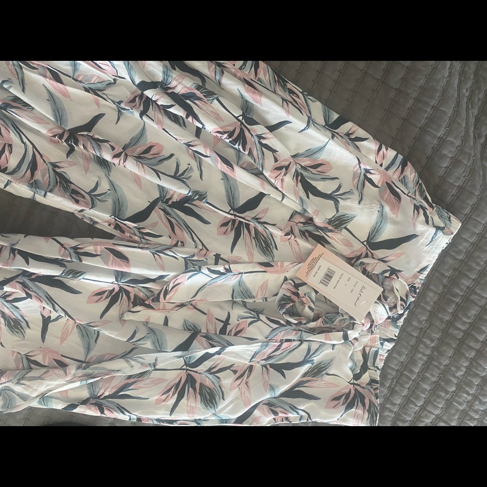 Two-piece outfit. Top and high front slit pants.